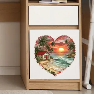Detailed close-up of a heart-shaped beach sunset sticker on a wooden cabinet