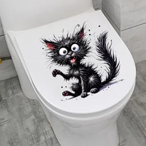 Detail eines lustigen schwarzen Cartoon-Katzen-Aufklebers auf einem weißen Toilettendeckel