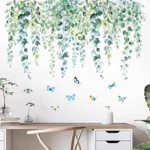 Detailed view of green eucalyptus vine and blue butterfly wall stickers on a white wall