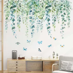 Macro view of eucalyptus leaf and butterfly wall stickers in a cozy living room decor.
