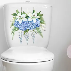 Watercolor floral decal detail on a white toilet tank with lilies and hydrangeas.