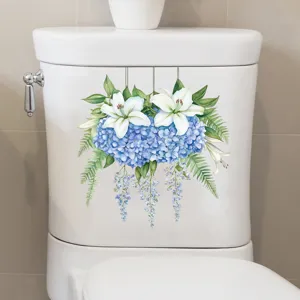Detail view of blue hydrangea and white lily floral sticker applied on toilet tank