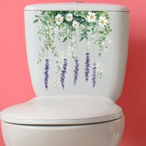 Detail showing floral toilet sticker with daisies and hanging vines on a white lid.
