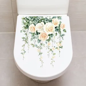 Detail showing floral rose and vine stickers on a white toilet lid for bathroom decor