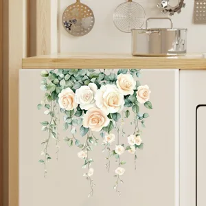 Detail view of decorative floral rose vine sticker applied to a cream kitchen cabinet