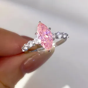 Detailed macro shot of a stunning pink marquise zircon ring with sparkly side stones
