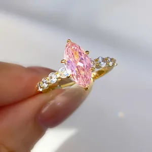 Close-up macro detail of a marquise-cut pink zircon ring with gold claw setting