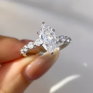 Close-up macro detail of a sparkling marquise-cut zircon ring with prong-set stones.