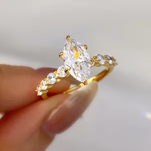 Detailed view of a gold-plated marquise-cut zircon ring with sparkling accent stones