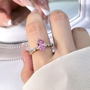 Exquisite gold ring featuring a sparkling pink marquise zircon stone shown on finger