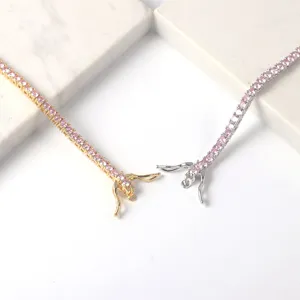 Detailed view of round pink tennis chain necklaces featuring secure box clasp mechanism