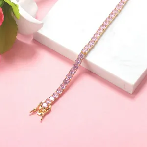 Detailed view of round pink gemstones on a gold-plated tennis necklace chain