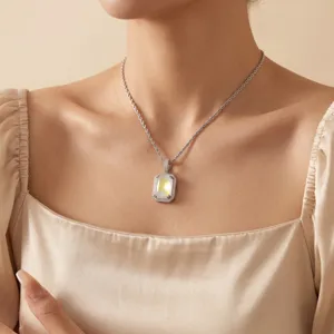 Detail view of a luxury square fluorescent zircon pendant necklace worn by a model