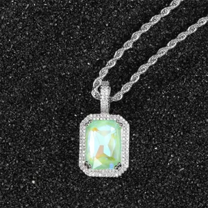 Close-up of radiant rectangular fluorescent green zircon pendant with pavé halo detail