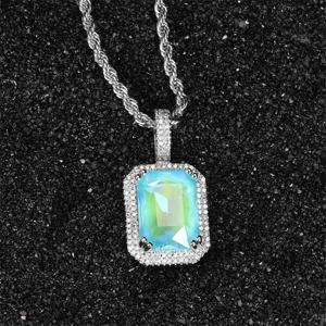 Close-up detail of a silver rope chain necklace with a vibrant fluorescent zircon pendant.