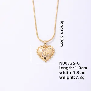 Gold heart letter pendant necklace detail, vintage metal minimalist clavicle chain.