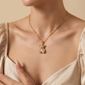 Gold-plated micro-pave cubic zirconia bear pendant necklace, elegant jewelry detail view.