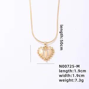Gold-tone heart pendant necklace with rhinestone letter M and snake chain for women.