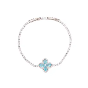 Silver tone tennis bracelet featuring a blue four leaf clover charm with sparkling cubic zirconia.