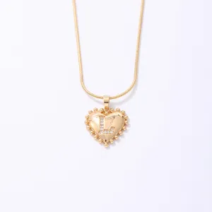 Gold heart letter necklace with sparkling rhinestone L pendant and elegant snake chain main view.