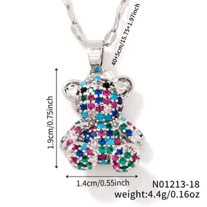 Detailed close-up of colorful cubic zirconia teddy bear pendant necklace with silver chain.