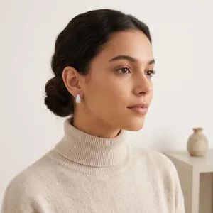 Model wearing pavé-set cubic zirconia U-shaped earrings with beige sweater.