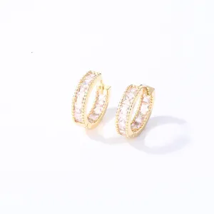 Gold hoop earrings detail showing square cubic zirconia stones and delicate beaded edge design.