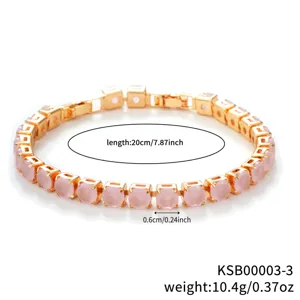 Close-up view of the luxury gold-tone tennis bracelet featuring sparkling pink cubic zirconia.