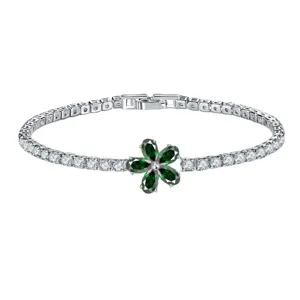 Elegant silver tennis bracelet with a green zircon flower charm in a minimalist design