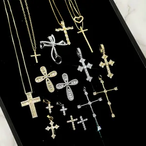 Macro view of assorted hip hop cross pendants featuring gold and silver stone settings
