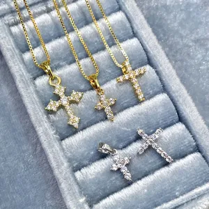 Detailed macro view of assorted vintage cross pendants with cubic zirconia inlay