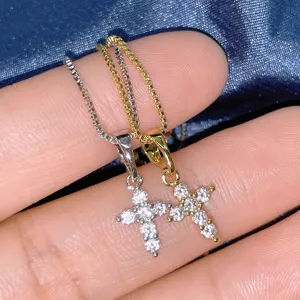 Close-up detail of silver and gold cross pendants with shimmering cubic zirconia stones