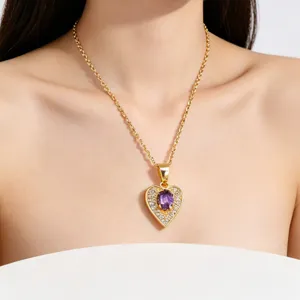 Close-up of heart-shaped necklace with purple gemstone and sparkling zircon stones