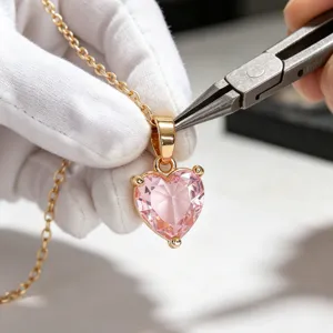 Close-up detail of a pink heart cubic zirconia pendant necklace featuring gold-plated chain.