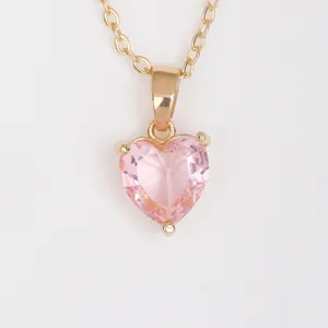 Detailed shot of gold plated pink heart cubic zirconia pendant necklace charm close up view.