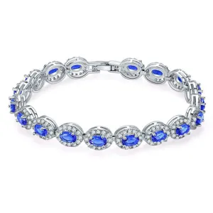Detailed view of elegant silver bracelet with oval blue zircons and halo diamond setting