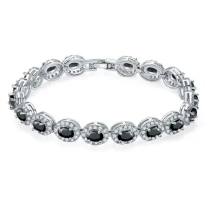 Close-up of silver-toned bracelet featuring oval black stones with halo zircon accents.