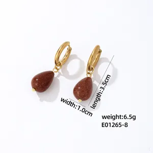 Detailed view of elegant gold hoop earrings featuring sparkling brown goldstone teardrop pendants.