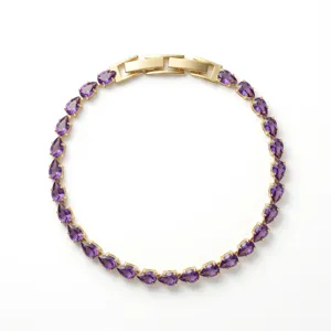 Elegant gold tennis bracelet with purple teardrop-shaped zircons on white background