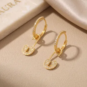 Macro detail view of 16K gold plated safety pin earrings with pave cubic zirconia accents