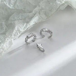 Detailed view of minimalist silver non-pierced ear cuffs with star and rectangular gem accents