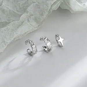 Detailed macro view of minimalist silver ear cuff set with star and CZ designs