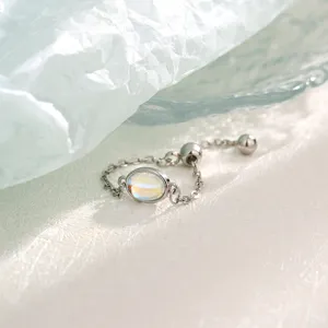 Close-up view of an adjustable silver chain ring featuring a radiant oval moonstone stone