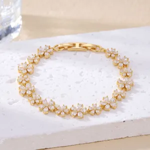 Macro view of gold flower bracelet with sparkling marquise-cut crystal petals