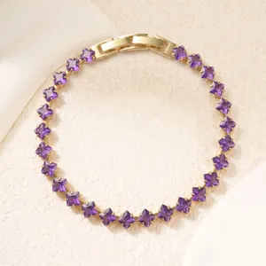 Top-down view of a gold-plated copper bracelet featuring square-cut purple zircons