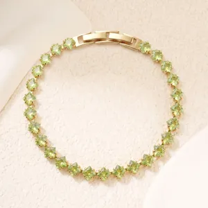 Macro detail of a elegant apple green copper-inlaid zirconia tennis bracelet for women.