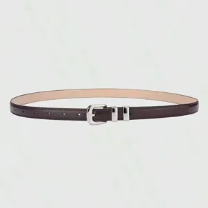 Close-up detail of slim women's dark brown leather belt with shiny silver metal buckle.