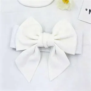 Close-up detail of a stylish white large bow belt for dresses with elastic band