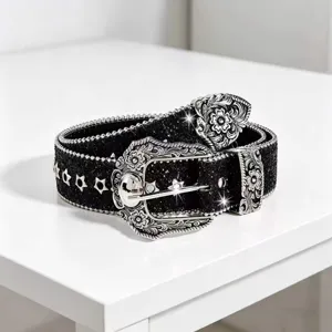 Close-up of black glitter western belt with silver carved floral buckle and star studs detail.