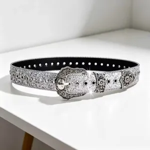 Silver glitter western style belt with ornate carved metal buckle for women fashion.